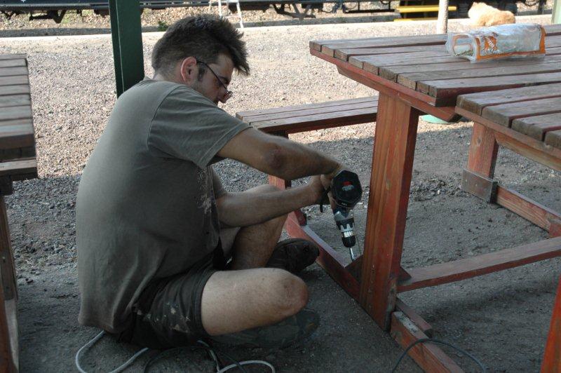 The tables and chairs get some attention at the Hermanstad site during the day