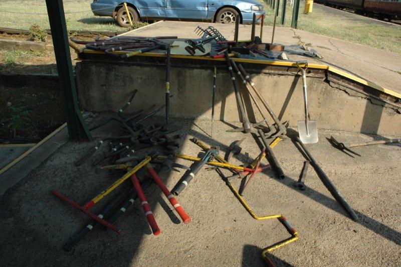 The rail tools and general spades and fork stuff was hauled out the big shed and a yellow identification band was painted on. The tools have the area masked off and ready to be painted.