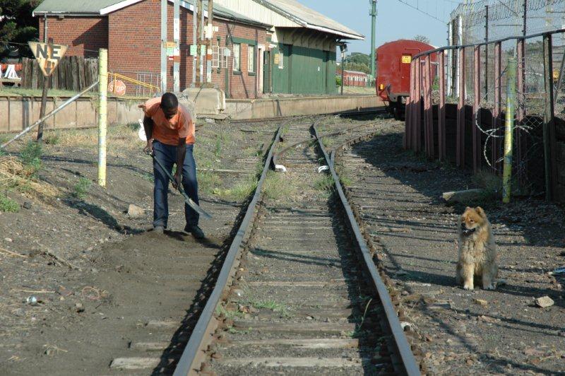 Charles at work clearing the ground and weeds off the tracks