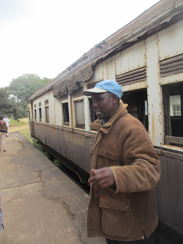 David Gitundu, chair of Friends of the Railway Museum, tells visitors about the restaurant car which stands behind the museum