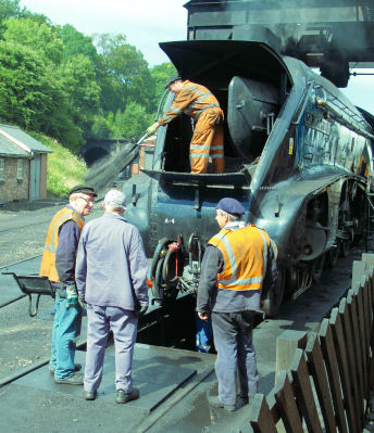 Shoveling the smoke box char into a wheelbarrow