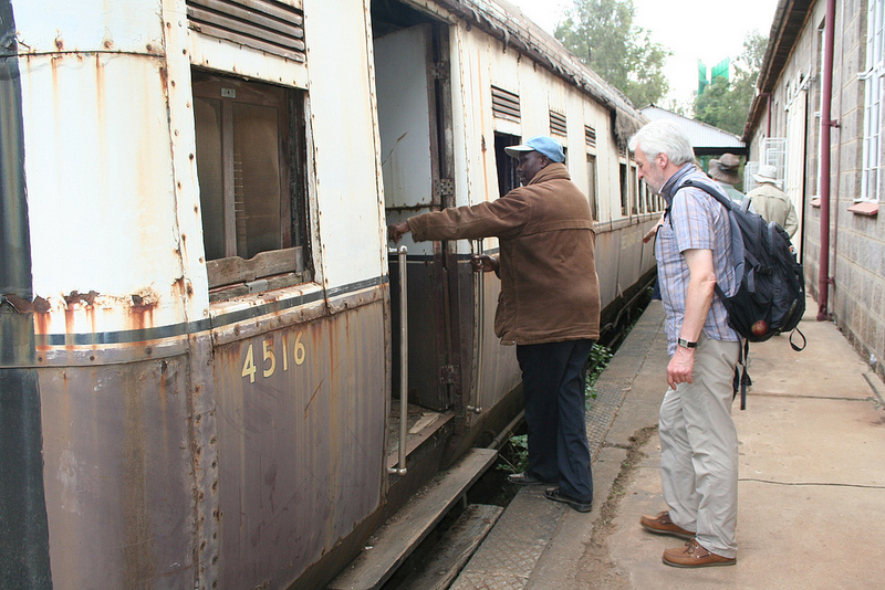 Friends of the Railway Museum chairman David Gitundu shows the restaurant car to a visitor