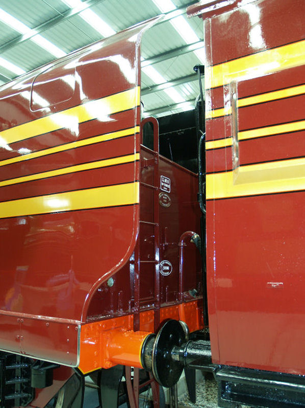 LMS 4-6-2 The streamlined fairing on the rear of the conventional tender with the front of the matching coach on the right.