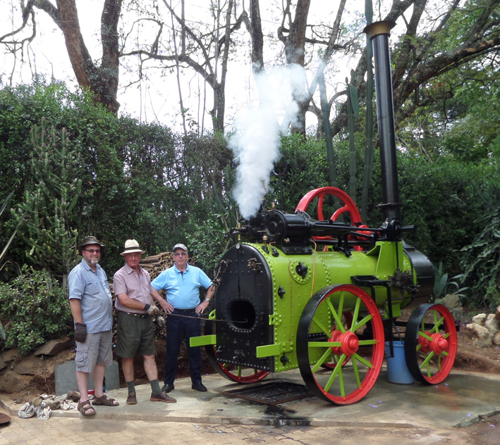 L to R: John Ashworth, Roger Tanner and Kevin Patience pose proudly by Roger's portable steam engine as she blows off steam