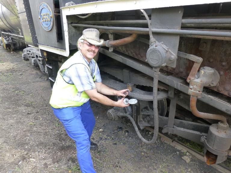 Trainee fireman Jaco learns how to grease the locomotive at Hermanstad early on Saturday morning in preparation for shunting duties