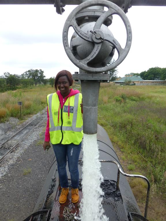 FOTR member Patience learns how to water the locomotive at Cullinan on the Friday trip. Patience aspires to become a fireman and eventually a driver, and loves steam because it is so "overwhelming".