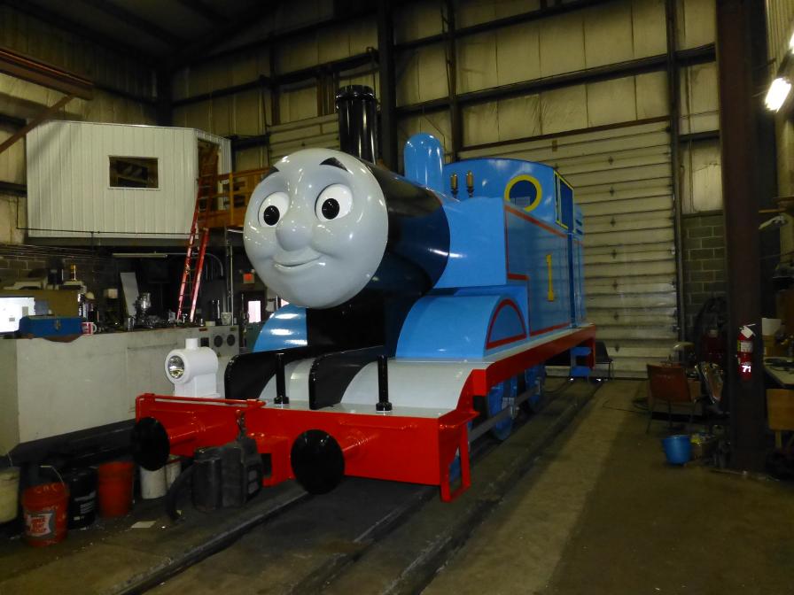 A replica Thomas the Tank Engine, which is non-operational and has to be pushed around by another locomotive.