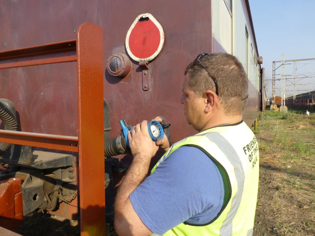 Guard Gabor does the vacuum test at the rear of the train before departure.