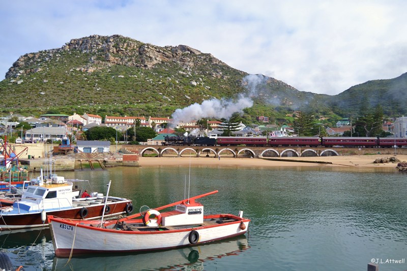 After a brief stop at Kalk Bay station, 879 storms out the station and crosses the small viaduct that runs parallel to the local harbor.