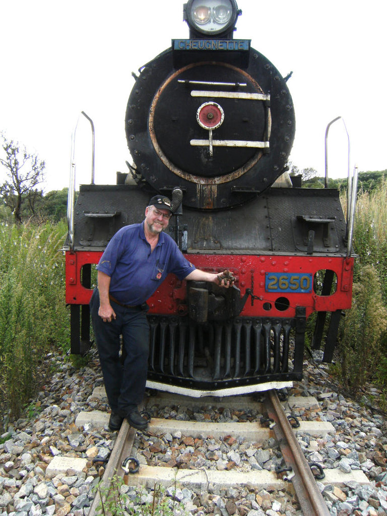 John, the fireman for the afternoon trip, poses in front of the loco in the cutting at Cullinan while checking for missing track bolts.