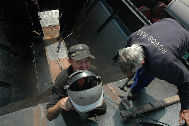 Work on 15F 3117 is nearing completion. Here we see "Spikkels" attempting to place the welding helmet on his head so as to show he is partly qualified as a welder. Shortly after the picture was taken, he was given a sound "Klap" for being too "Clever!"