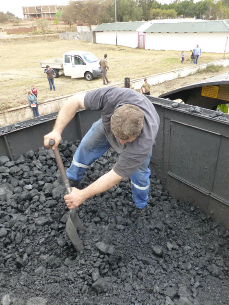 Everybody mucks in to trim the coal forward in the tender for the return trip; Gabor...