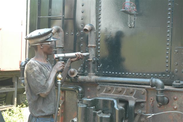 Removing years of built up paint is a time consuming task. Nataniel gets to grips with the air powered needle gun and has successfully removed layers of paint from buffers and vacuum pipes. The buffers will now receive a red coat of paint and the steps will get the safety yellow.<br /><br />Photo by Nathan Berelowitz 23/02/08