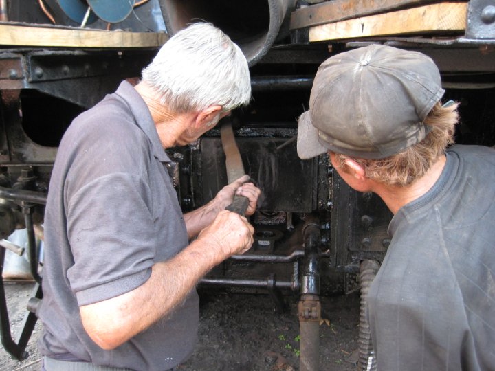 Uncle John manipulates a rod into place while Adriaan looks on