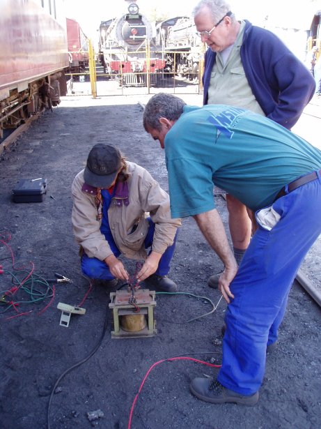 Mike tests a replacement transformer while Steve and Tom look on<br /><br />Photo by John Ashworth 18/08/07