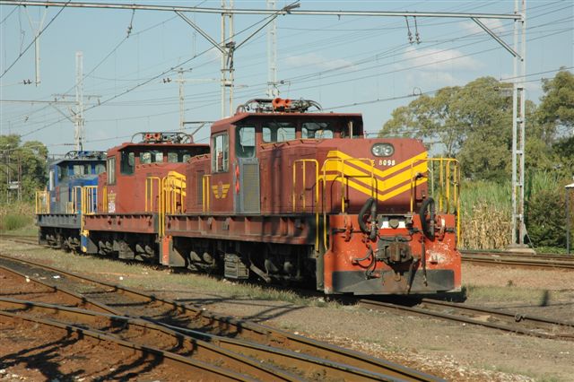 8 is enough! Three versions of the shunt/mainline loco class 8E at Capital Park. The centre unit has not yet been fitted with the cab air-conditioning units as seen on the sides of the other two. Then of course the different colour schemes.