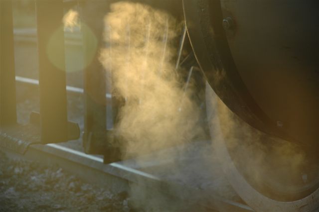 Late sunlight streams through the softly swirling steam as the locomotive pauses in her duties to admire the sunset!