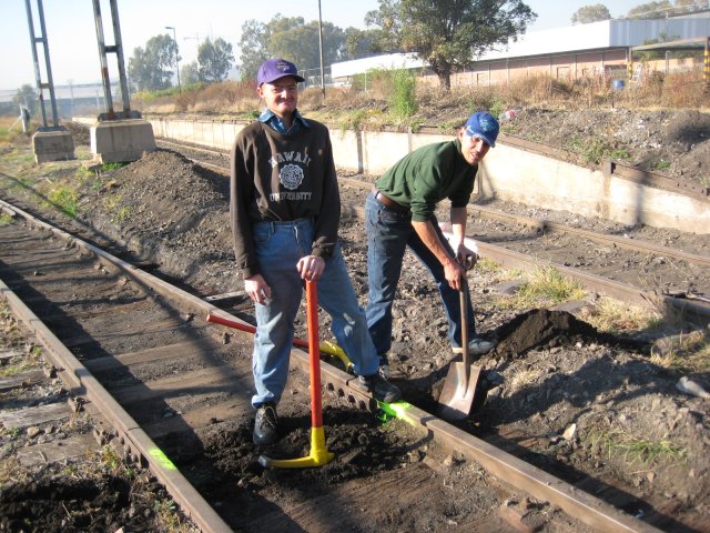 Adrian (left) and Frank dig out a sleeper that has been marked with yellow paint