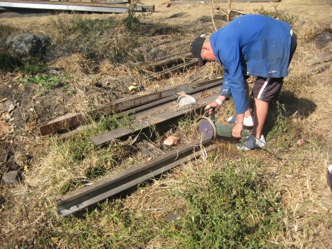 Koosie cuts scrap rails to form the fence posts<br /><br />Photo by John Ashworth 2nd July 2008
