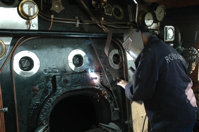The firebox door frame required a number of welds to build up the fastening studs, after years of use and corrosion. Oom John at work
