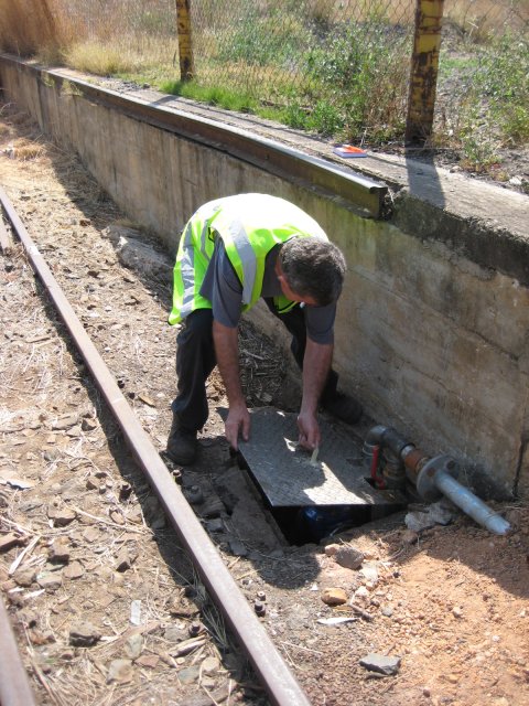 Steve manipulates the manhole cover