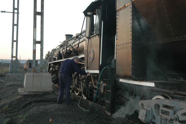 Having been stabled for the first time at the new site at Hercules, 2650 gets her ashpan rinsed out by driver Willem Ras