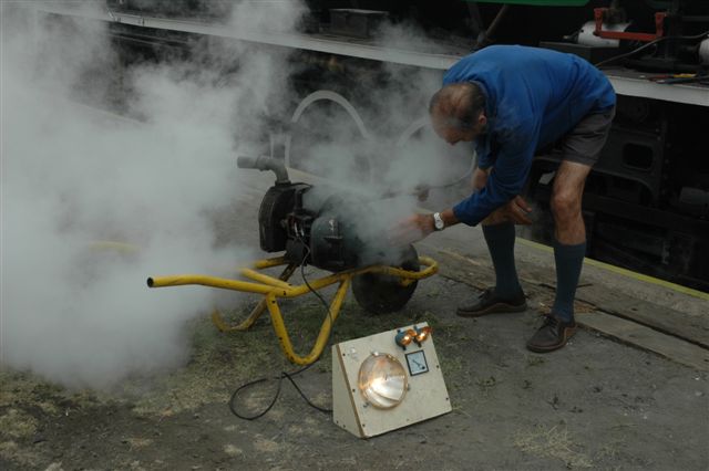 The dynamo works! Headlight and two cab lights will be operating at 32v, but first Robert Dadford makes the adjustments to get the required setting. Simple yet effective way of testing dynamos!