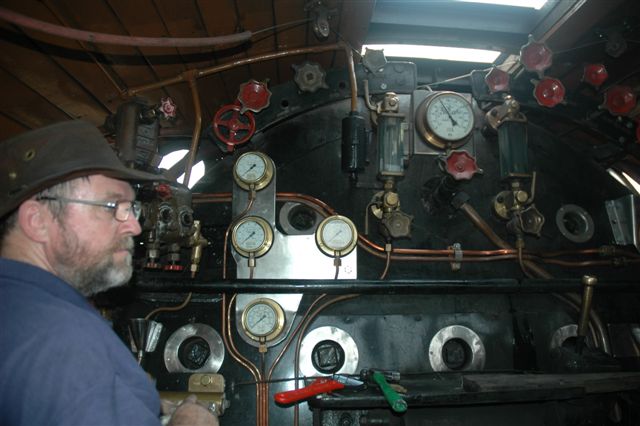 Earlier, Shedman/Fireman John Ashworth looks at the low steam pressure, as the locomotive is slowly brought up to working pressure<br /><br />Photo by Nathan Berelowitz 04/10/08