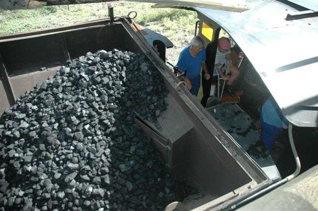 3117 has some coal loaded for the next firelight. In the cab, seated, is member Fanie Theron, with John Dadford