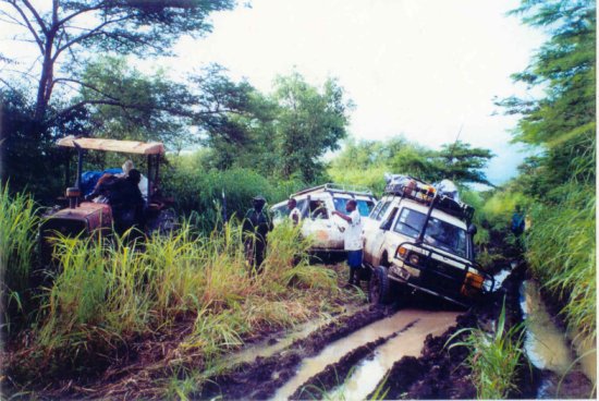 Ace Kenyan logistician John Kimotho (in shorts, centre) gives directions to a convoy stuck in the mud in southern Blue Nile