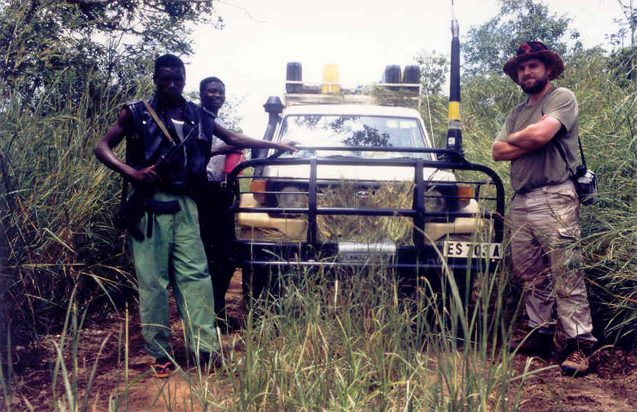 L to r, an SPLA security officer with CEAS staff William Oyet  and John Ashworth, near the front line on the Juba-Yei road, September 1997.