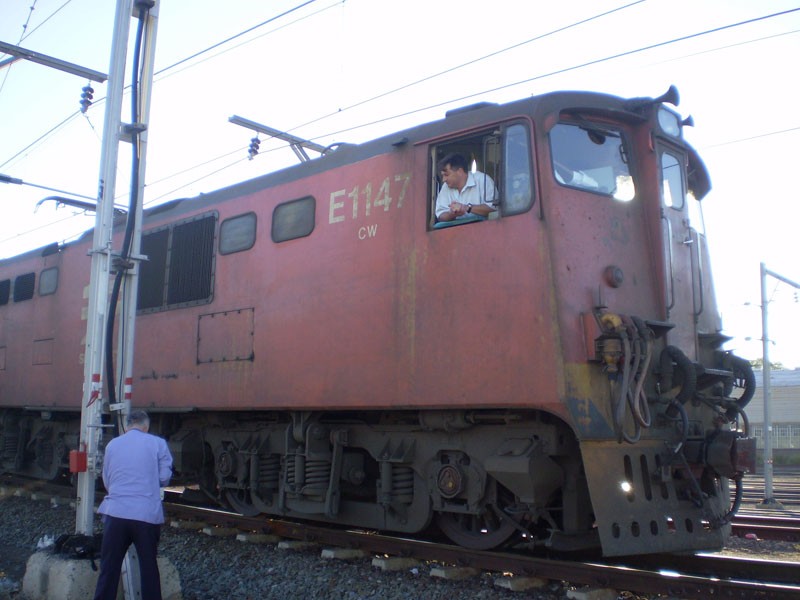 Train Manager Willie and 6E Driver chat at Beaufort West. (The paint work on the locomotives in the Western Cape are shocking)