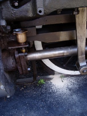 A small pile of sand lies on the track under the nozzle after the sanding gear was partially dismantled, cleaned, reassembled and tested.