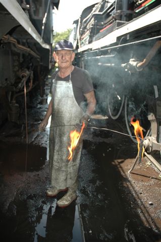 Boiler inspector Des Paton has his paraffin flare lamps ready to insert into the open washout plug areas, to examine the inner firebox. Some areas he will insert a small mirror, to have a look see, in the confines of the boiler