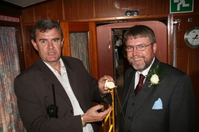 Steve and John are amazed that the wedding is not running to railway time - C Janisch