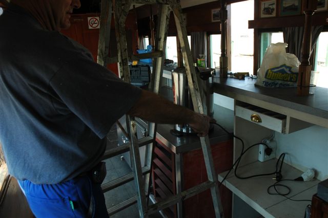 Steve Smith at work in the bar coach proud of his electrical installations, powered by the diesel generator