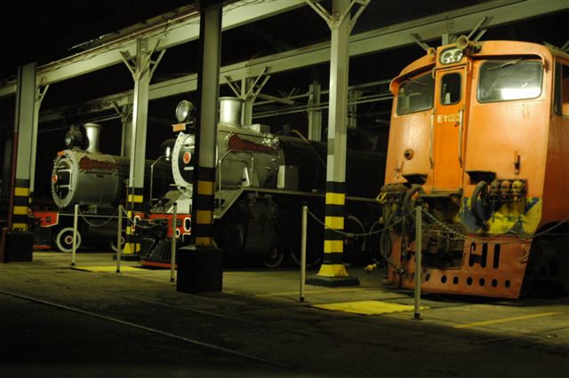 Current scene at Rovos Rail loco depot. The old 15m shop at Capital Park shed in years past. However, not only has the shed function changed, but the face of modern traction is now going to be familiar. Late series class 5E1 unit, one of three at present, awaits her turn to be put into service, whilst the two withdrawn class 19D, share their past experiences