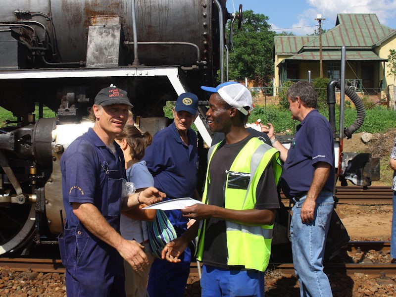 John Makopo receives his certificate from Nathan with John D and Steve S in the background<br />03/11/07 K R Wilson-Smith