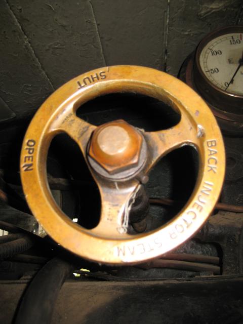 Fireman's side injector steam valve. The steam pressure gauge can just be seen at the top of this photo, mounted where neither driver nor fireman can see it easily.