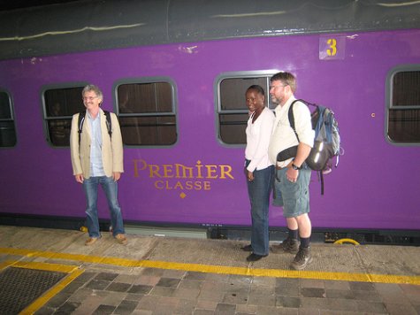 Nick, Jane and John check that they're on the right train by trying to read the big letters on the side of the coach