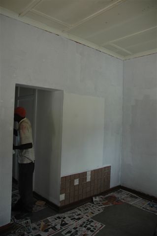 Looking at the new office area. The old notice board has been removed for the wall painting. The corridor leads to the kitchen and then there is a doorway in that corridor that will lead to a room alongside and the toilet area. Another couple of coats of paint to go!
