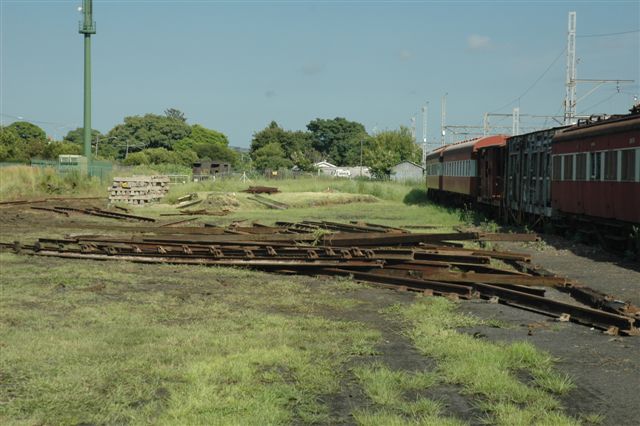Area of stacked rails removed from the embankment area near the cell phone tower in the background